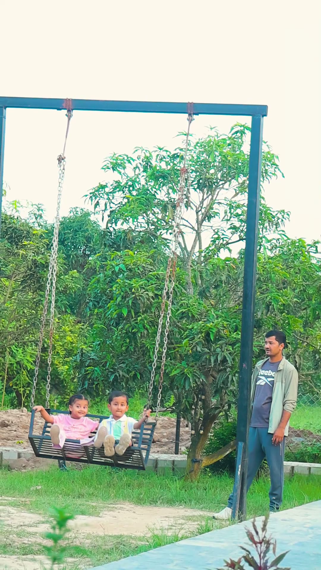 Children on the garden swing at the resort